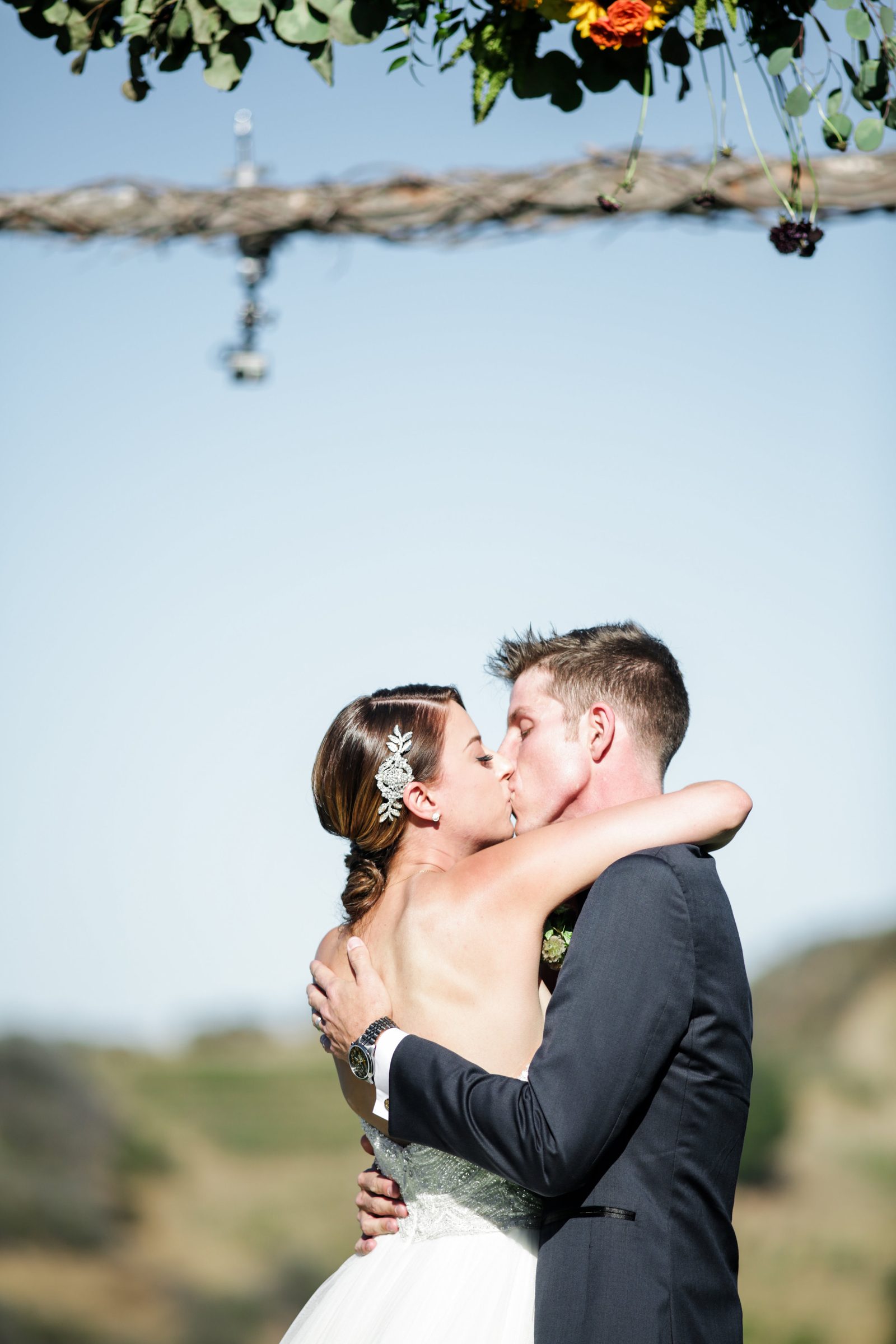 First kiss under sunflower arch